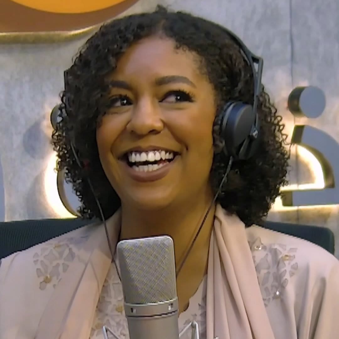 Asma laughing at the microphone
