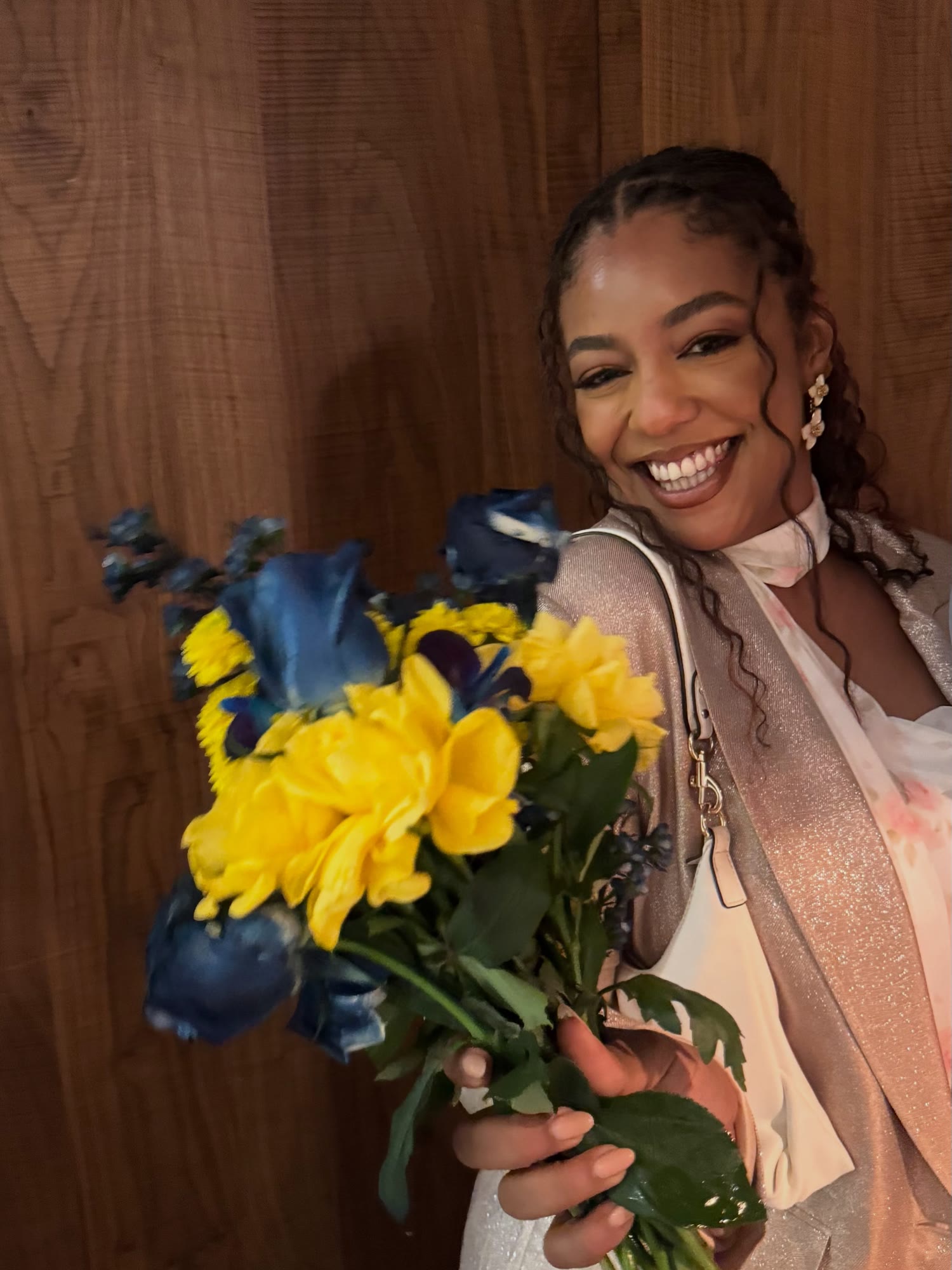 Asma holding yellow and blue flowers